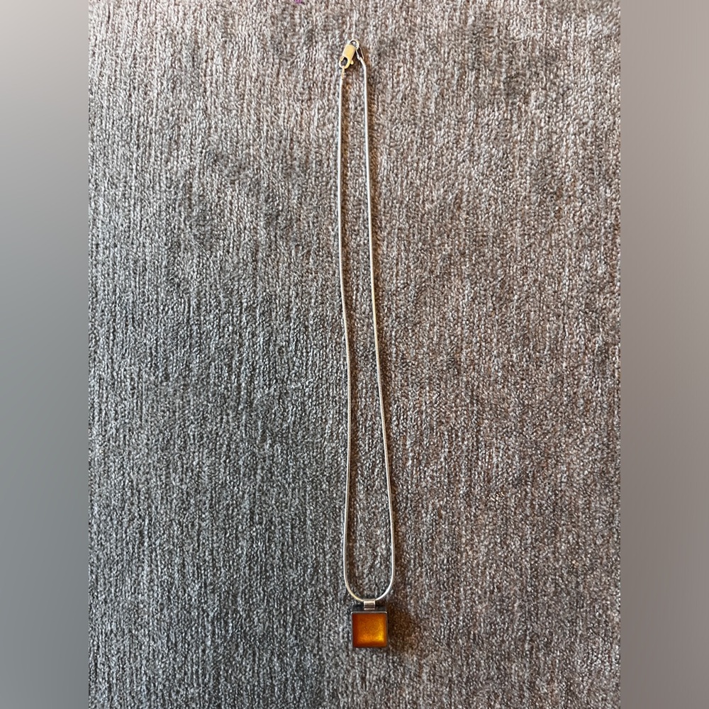 Petrified amber in silver heart square on silver chain